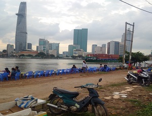 The dirt road and the patches of mud and grass behind the motorcycle offer a real feeling as to how empty the land is on the other side of the river. Locals use this riverside for the meantime to drink ca phe sua da, the country's trademark way to drink coffee with condensed milk, along with tra da, a jasmine tea, alongside conversation with friends.